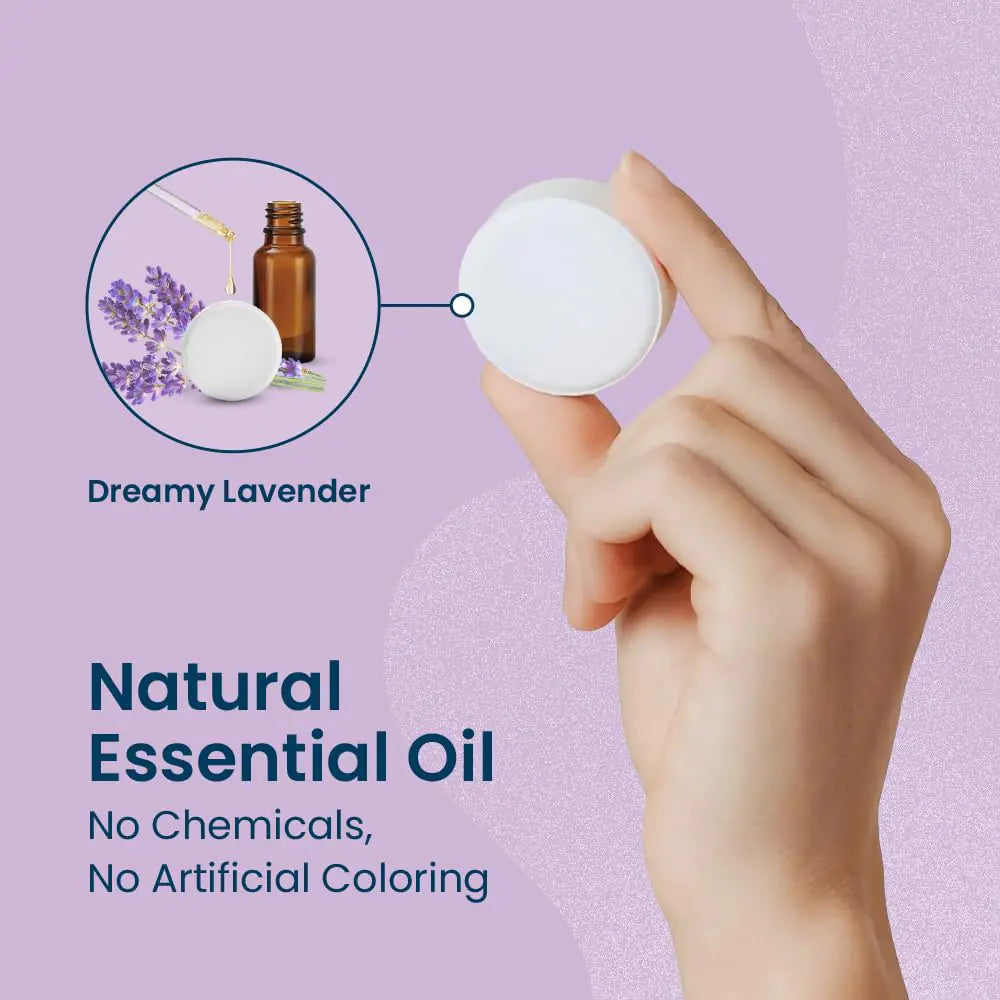 a hand holding a bottle of essential oil