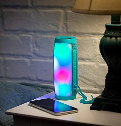 a table with a phone and a lamp on it