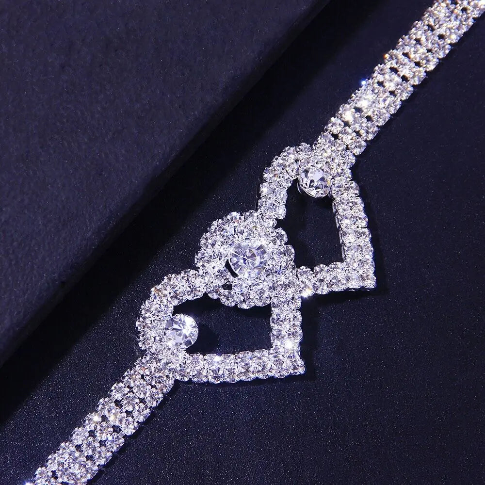 a diamond necklace on a black surface