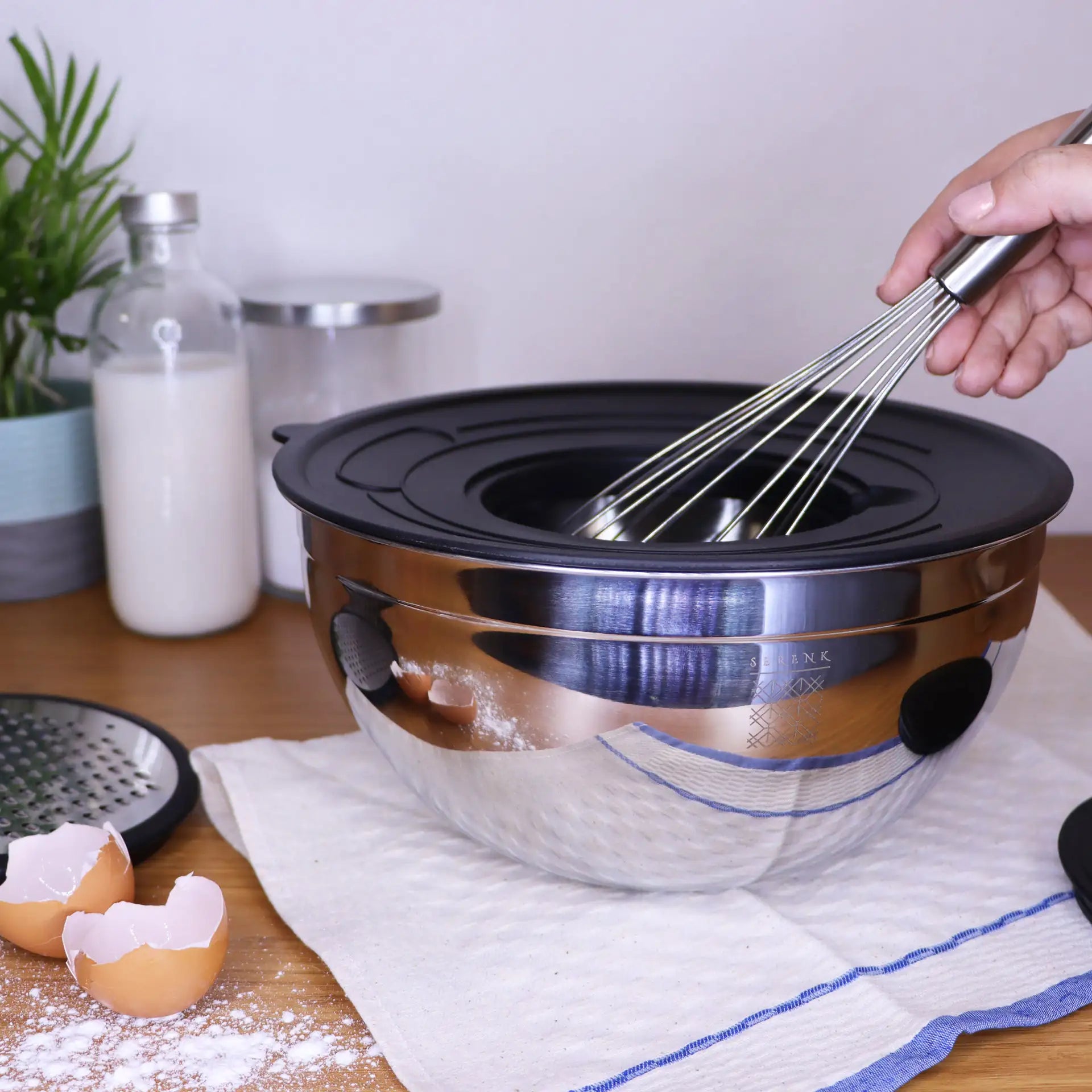 a person whisking eggs in a large bowl