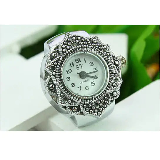 a watch sitting on top of a white table