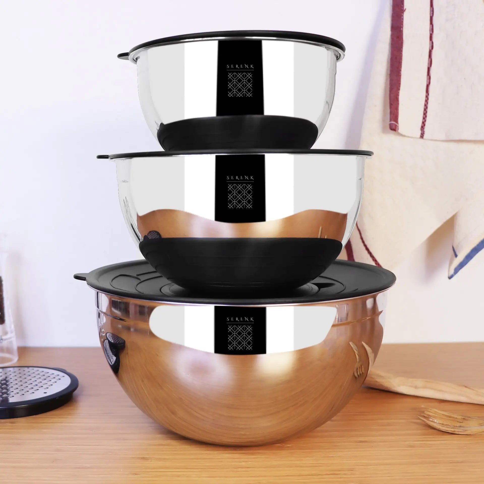 a stack of three bowls sitting on top of a wooden table