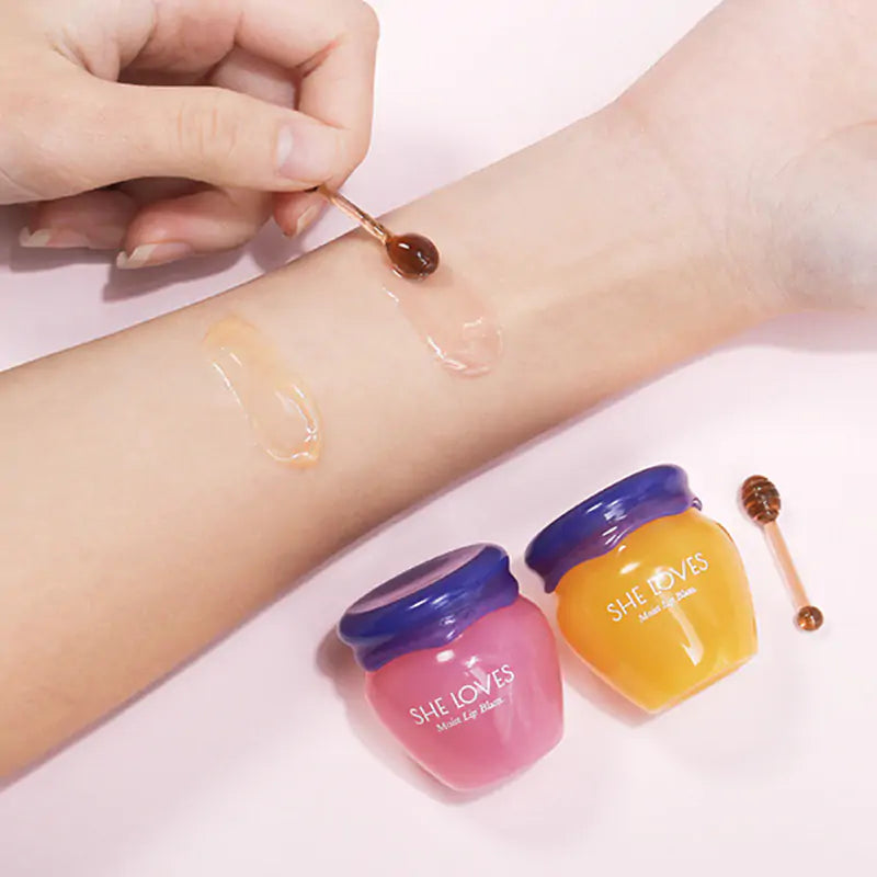 a woman's arm with three jars of jelly on it