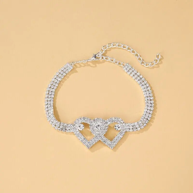 a bracelet with a heart shaped clasp on a chain