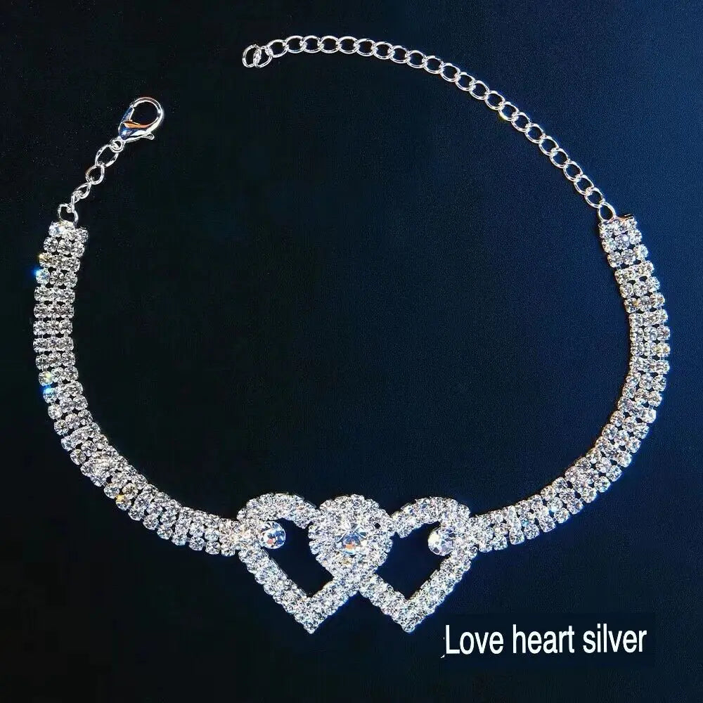 a necklace with two hearts on a black background