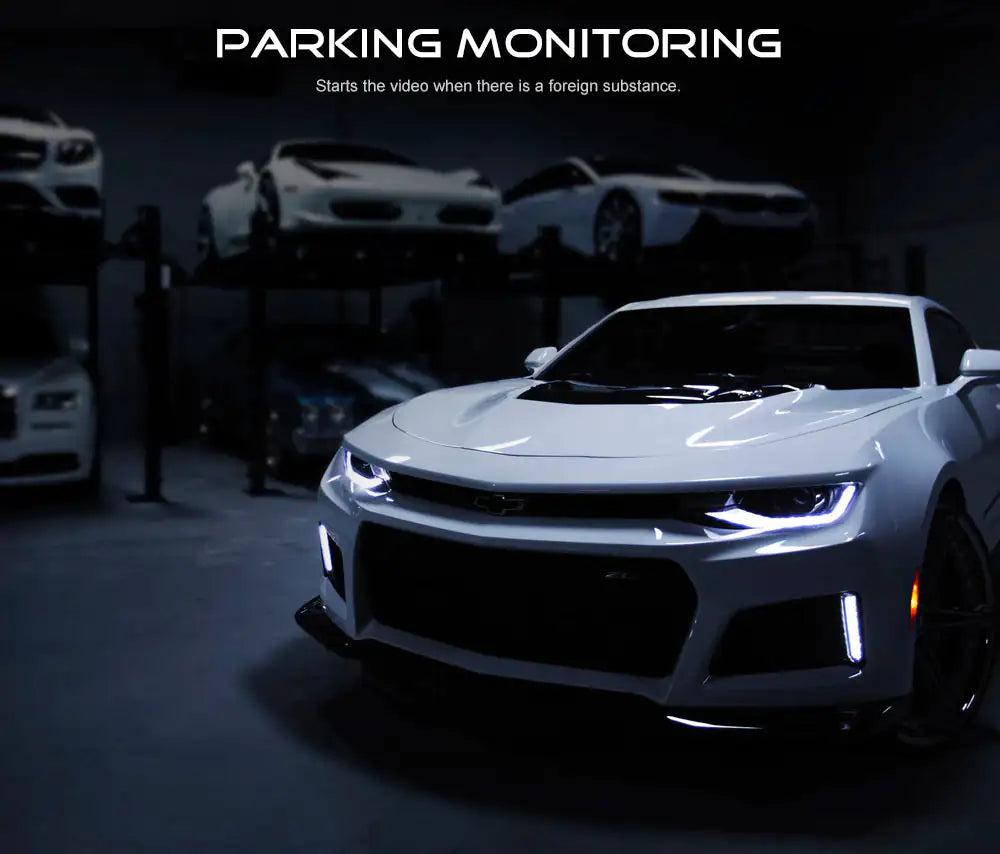 a white chevrolet camaro is parked in a garage