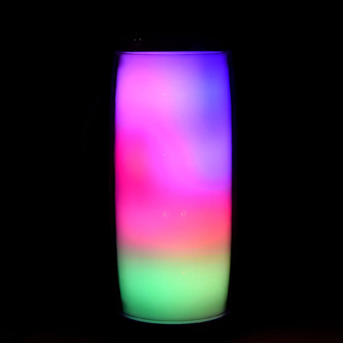 a lit up vase sitting on top of a table