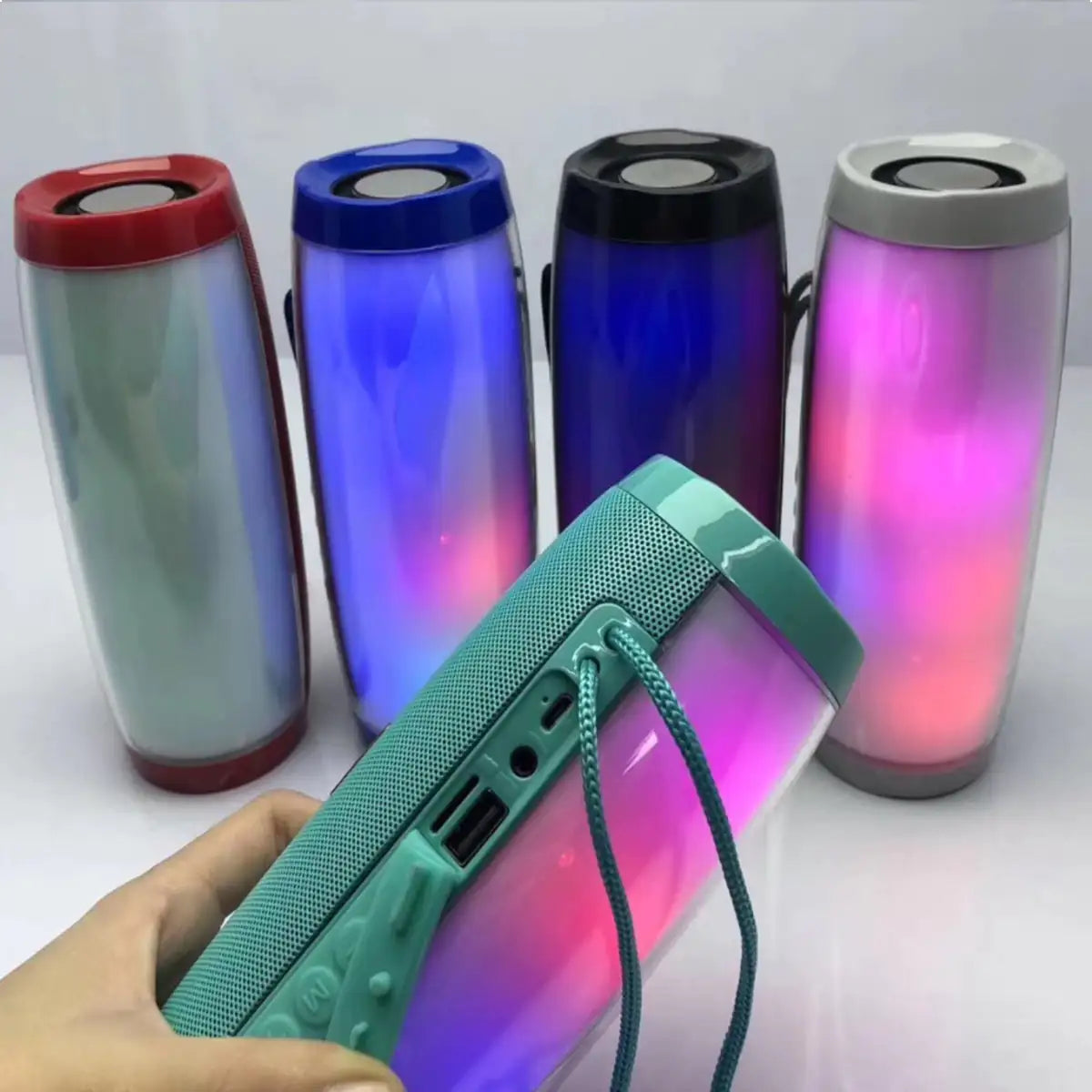 a person holding a bluetooth speaker in their hand