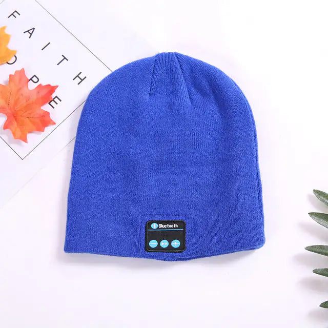 a blue beanie hat sitting on top of a table