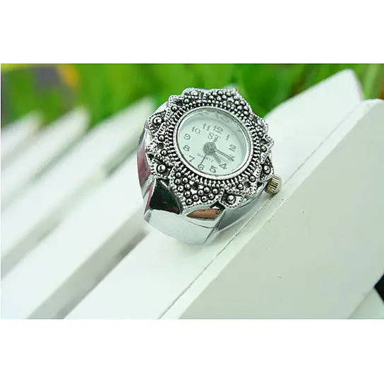 a watch sitting on top of a white bench