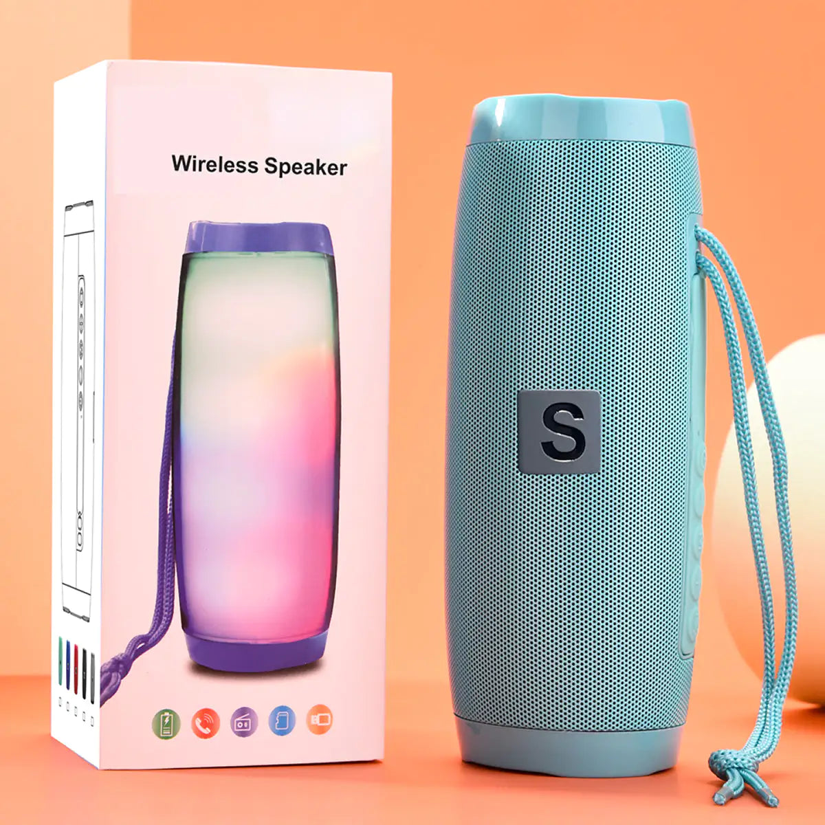 a wireless speaker next to a box on a table