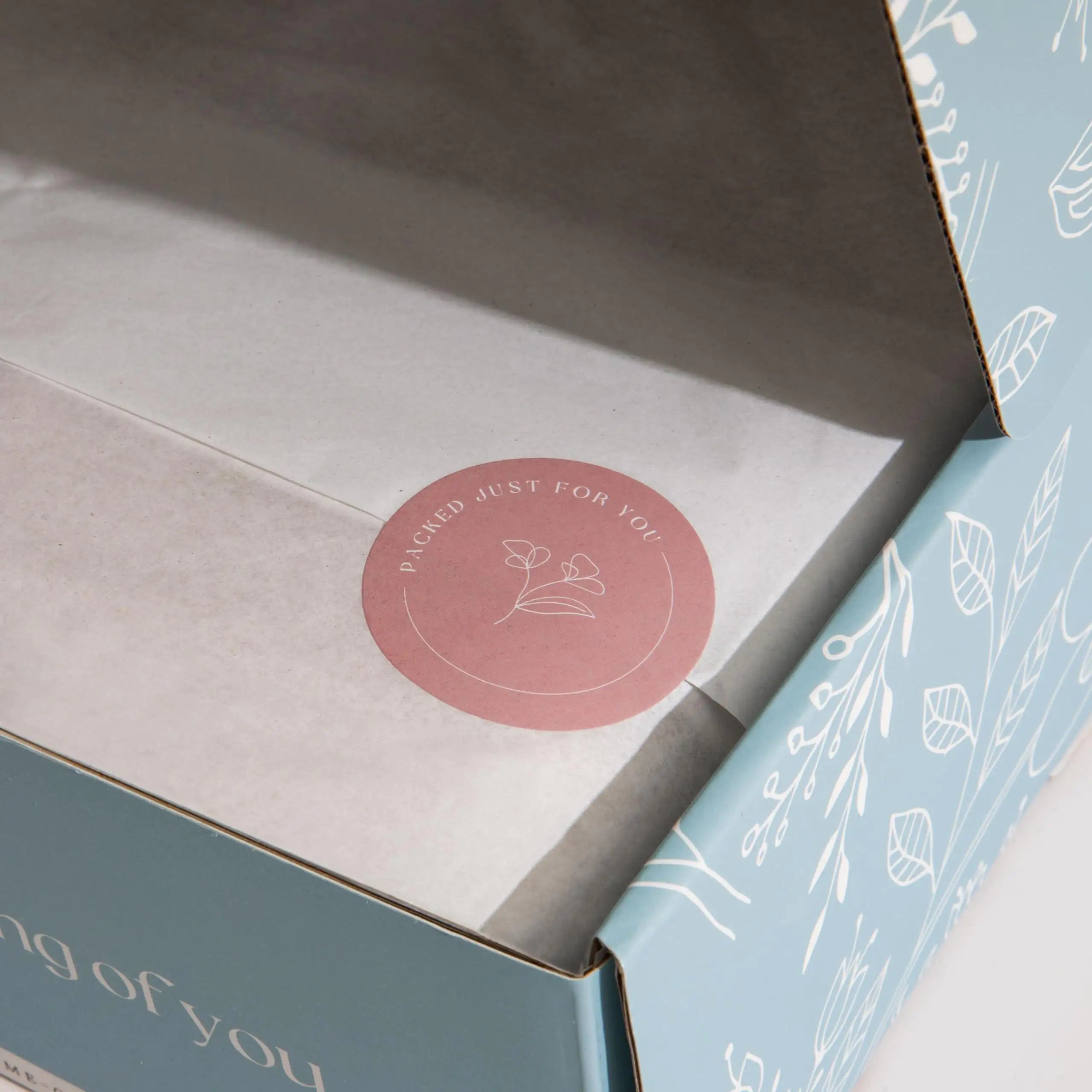 a blue box with a pink sticker on it