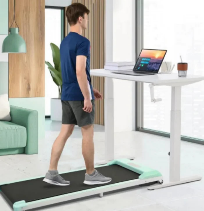 a man walking on a treadmill in a living room