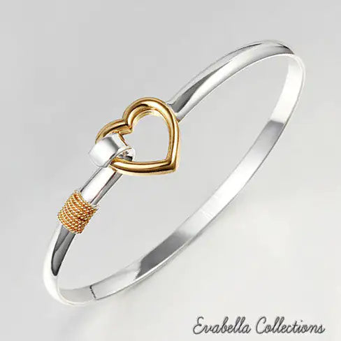 a gold and silver bracelet with a heart on it