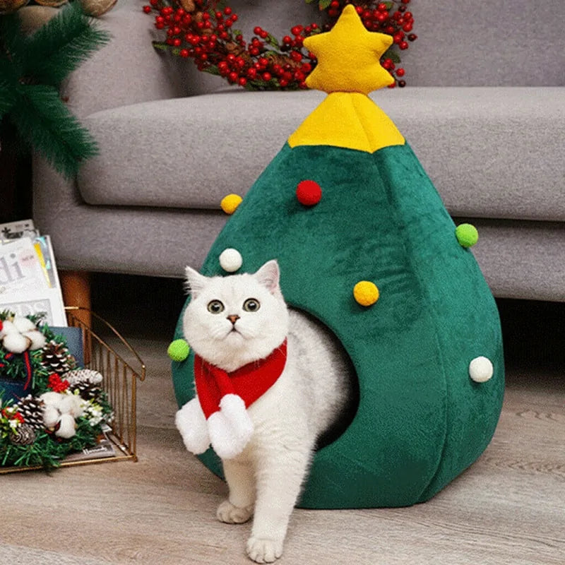 a white cat standing next to a christmas tree