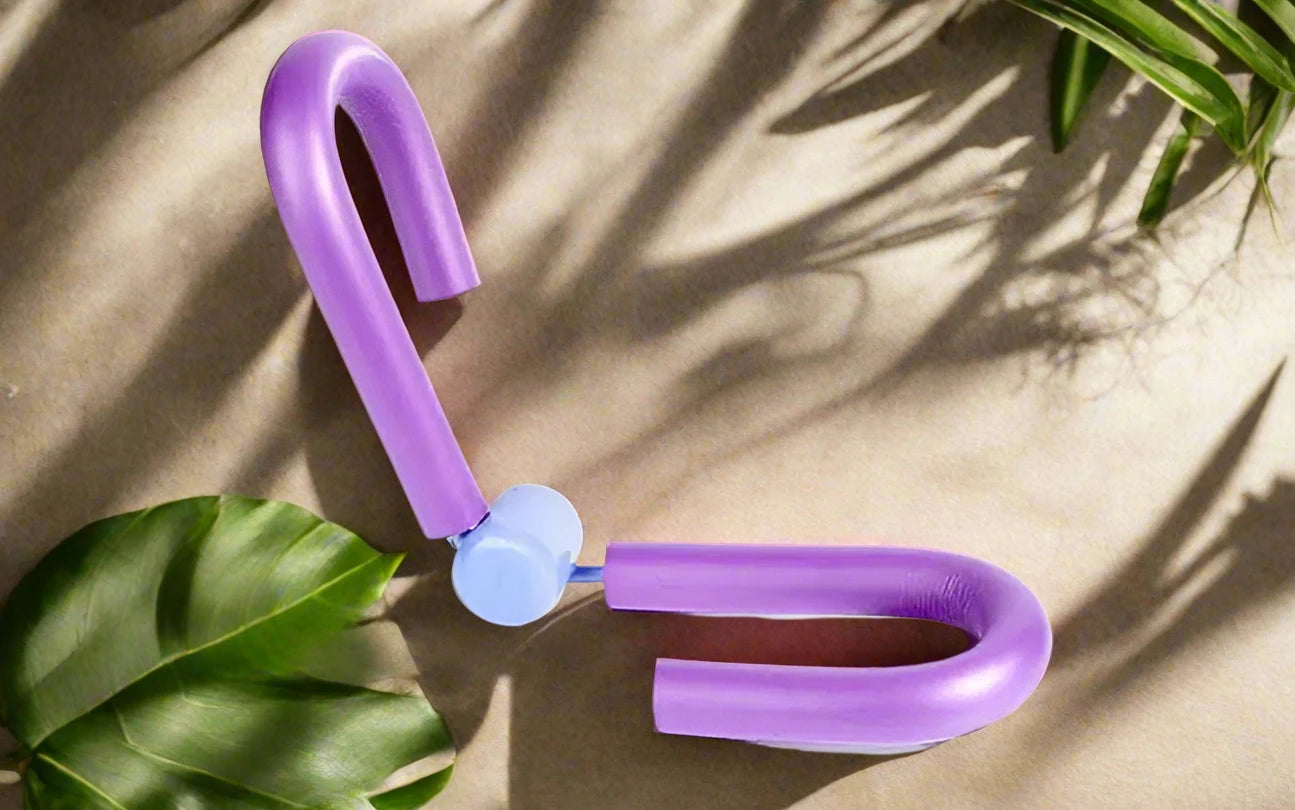 a purple pair of scissors sitting on top of a table