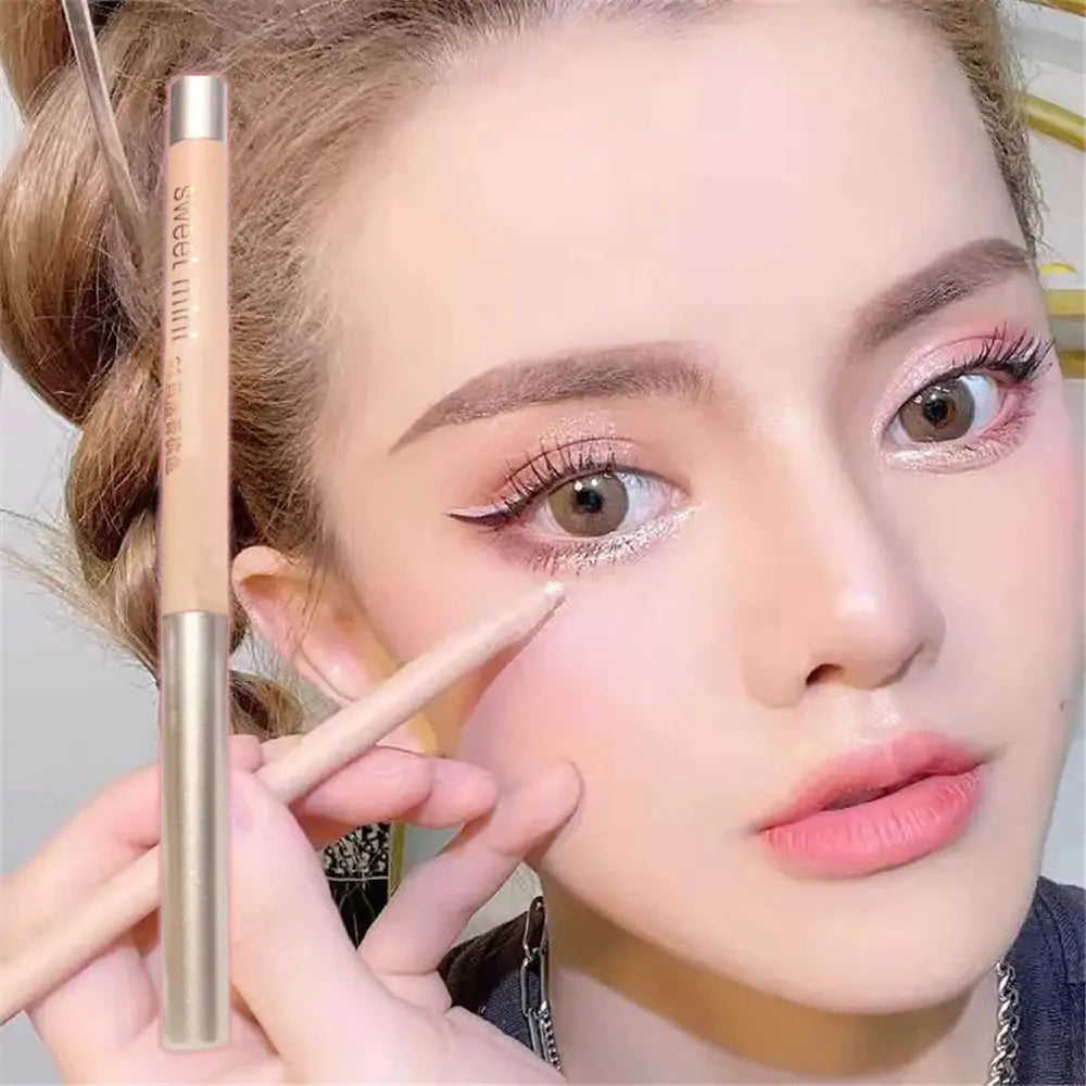 a woman putting a pencil on her eye