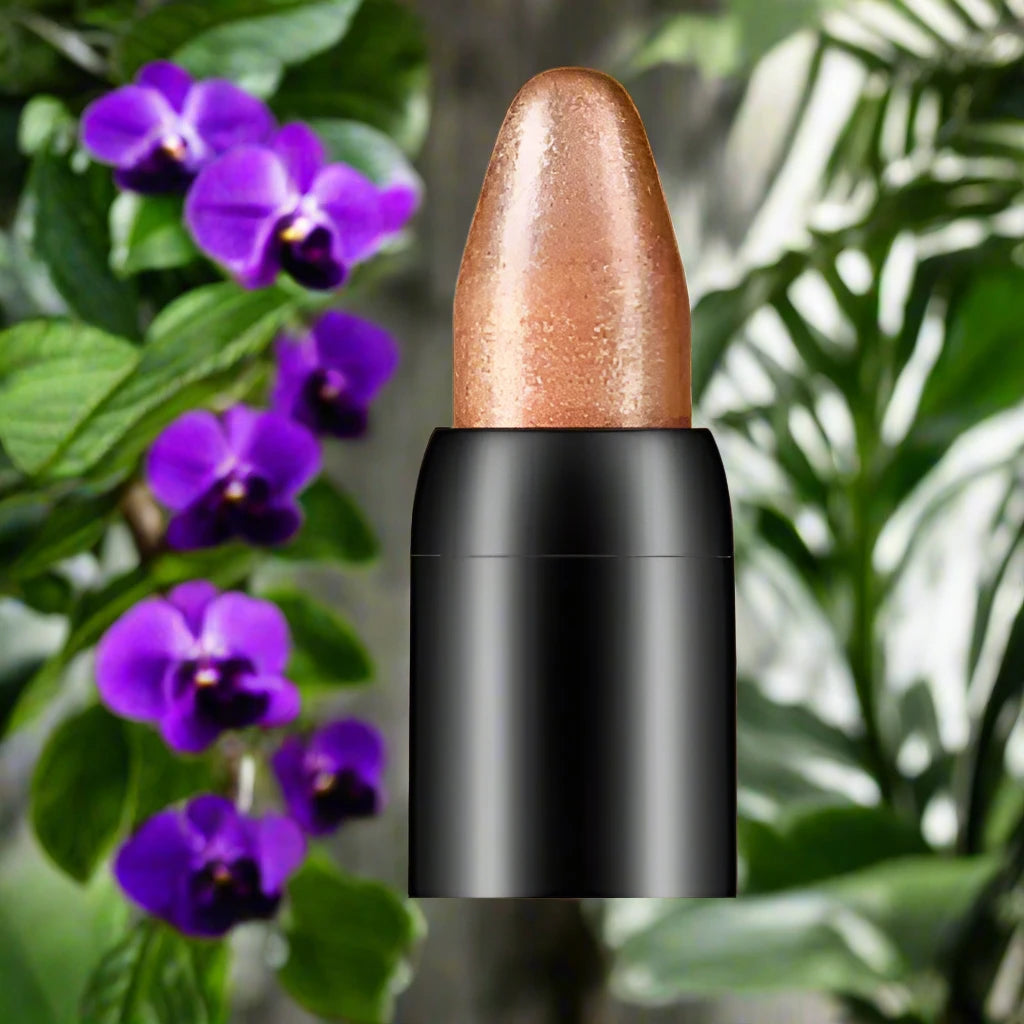 a close up of a lipstick in front of purple flowers