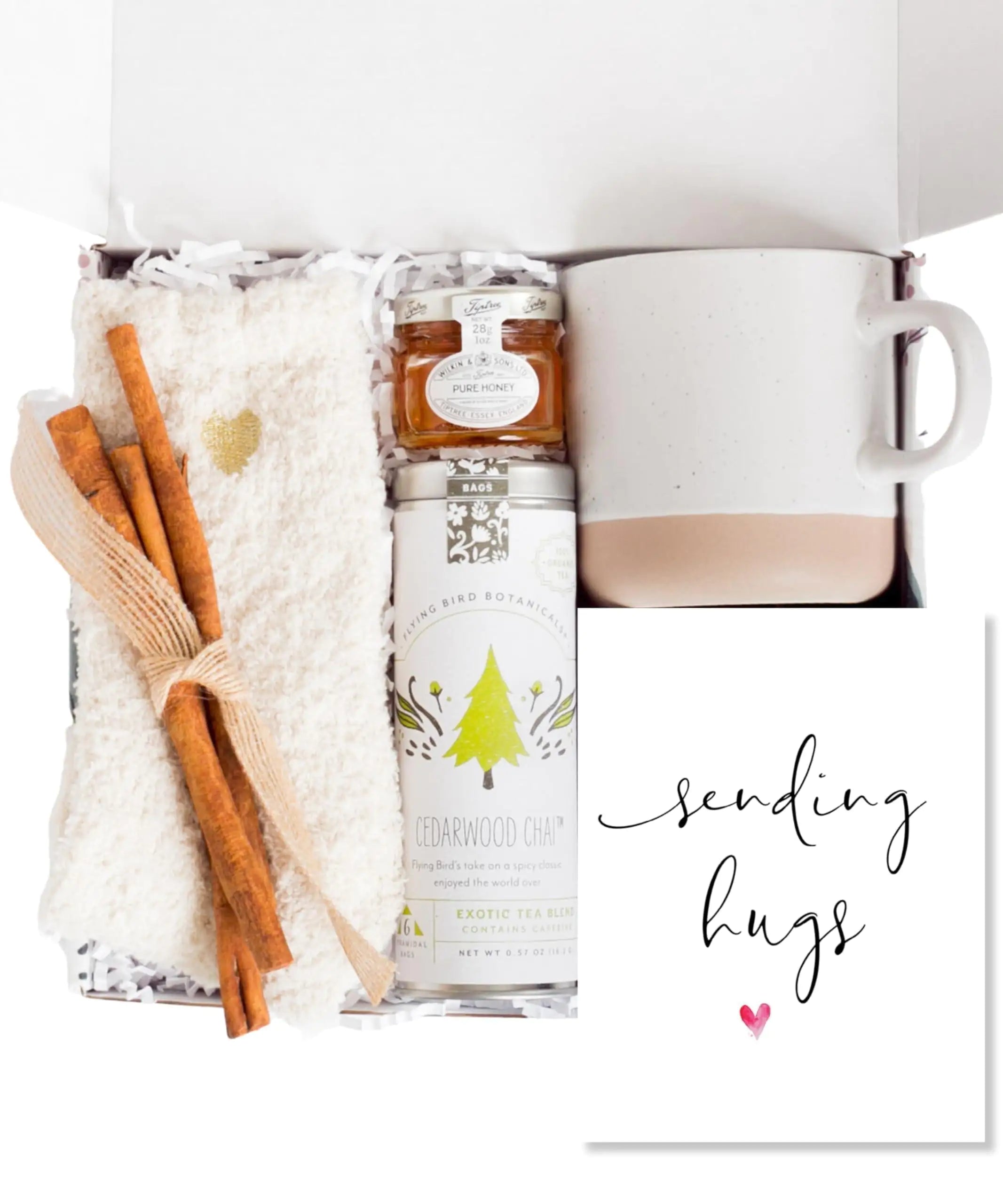 a box with cinnamons, a mug, and a towel