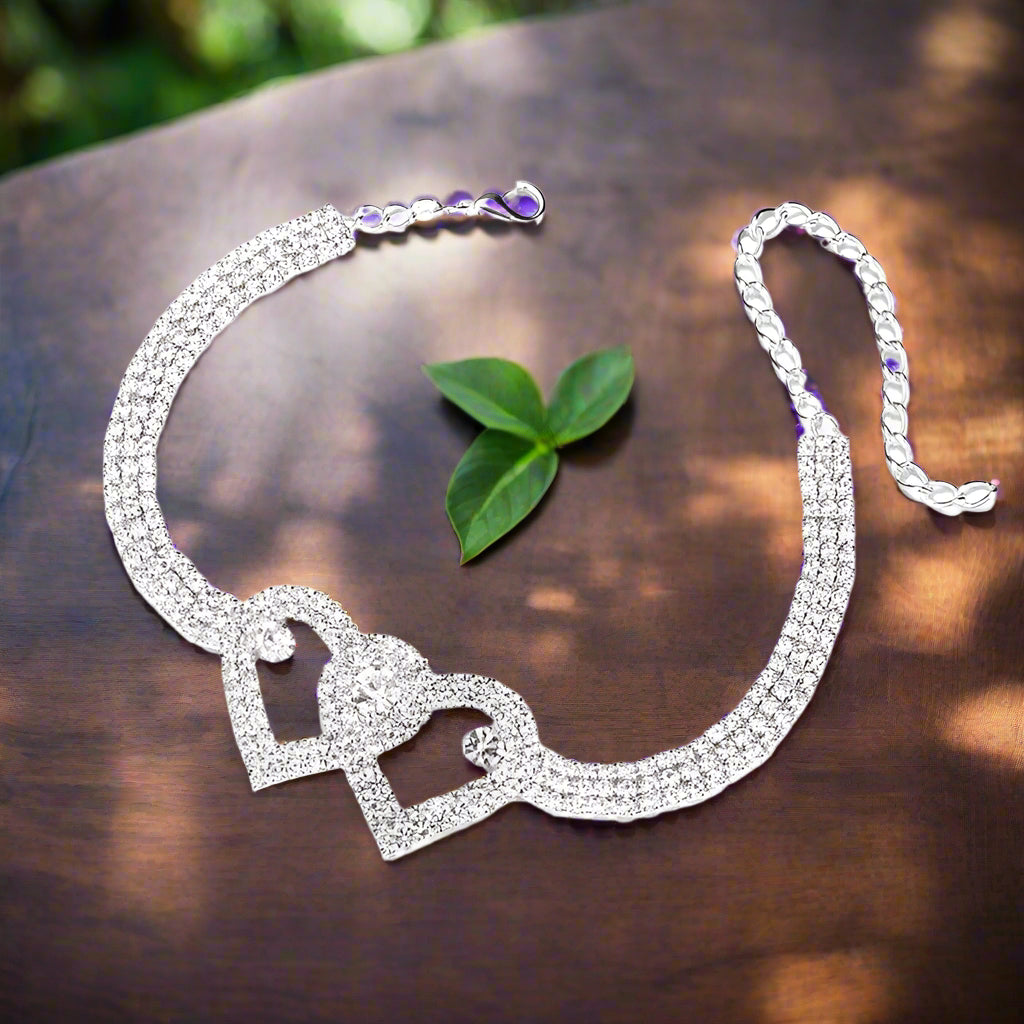 a necklace and a leaf on a table