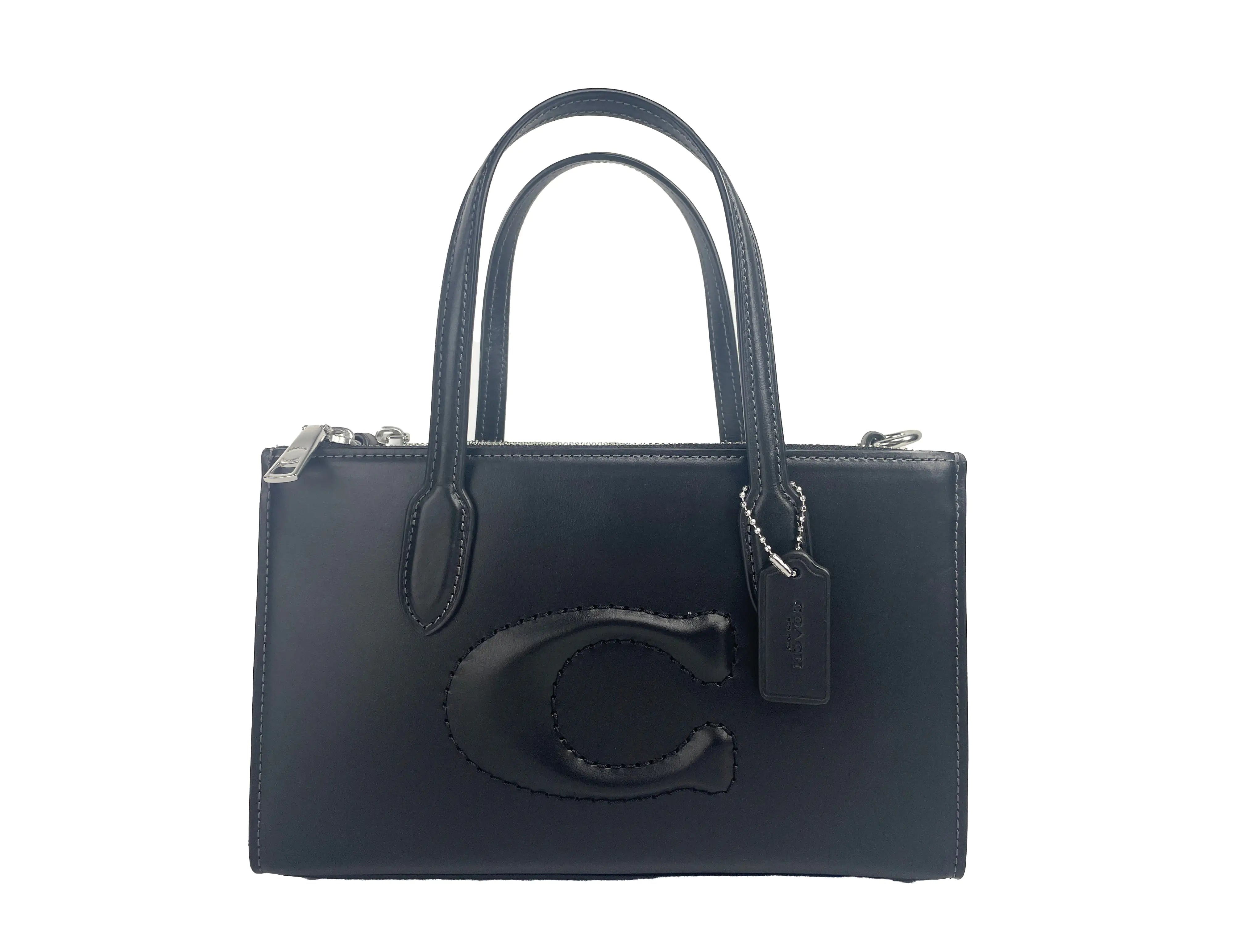 a black handbag with the letter c on it