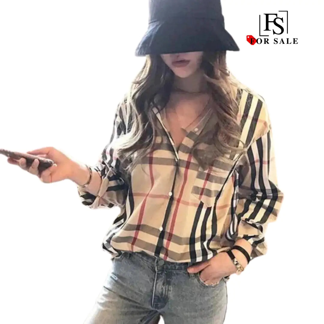 a woman wearing a hat and holding a cell phone