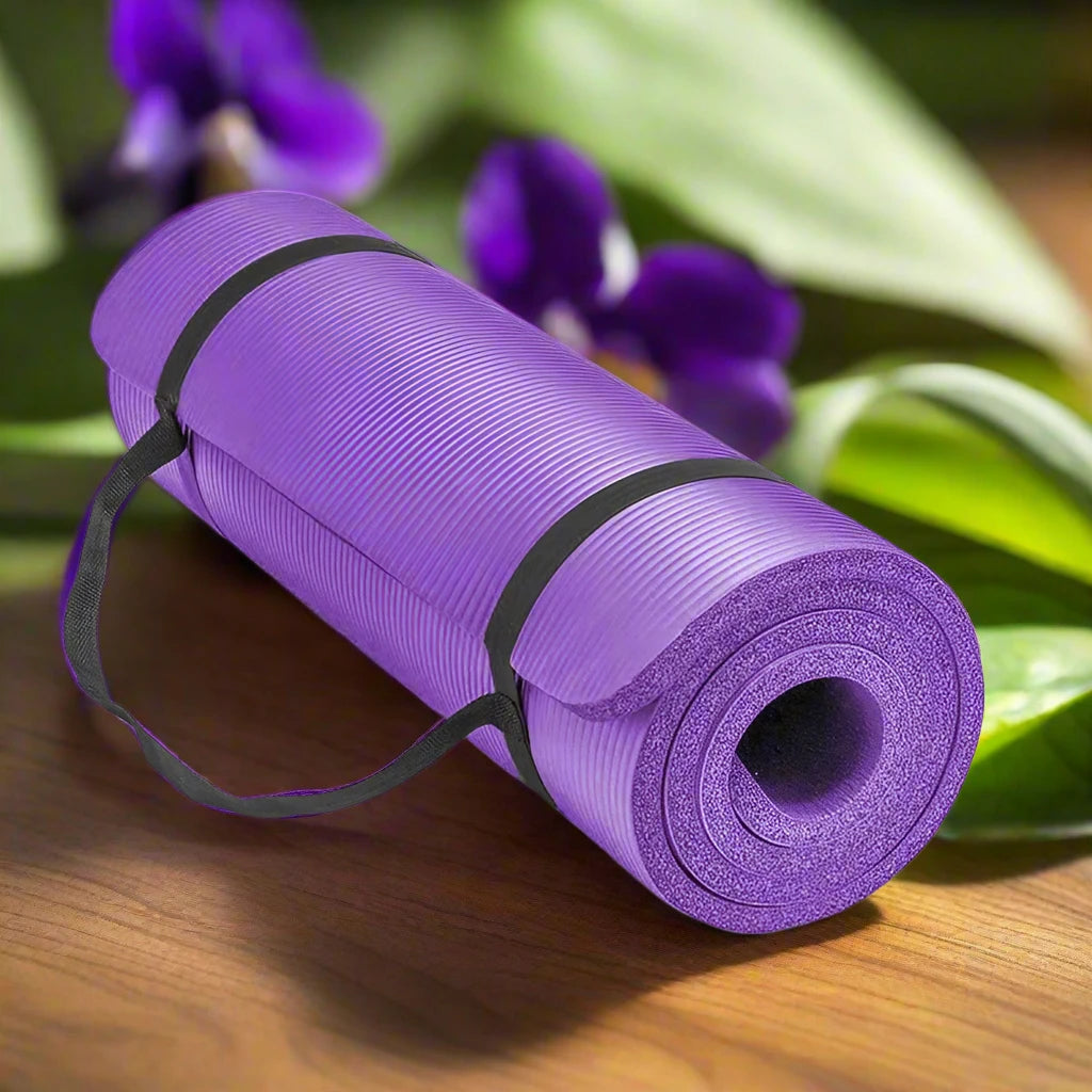 a purple yoga mat and purple flowers on a wooden table