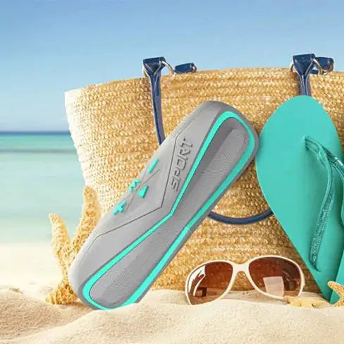 a pair of flip flops, sunglasses and a straw bag on a beach