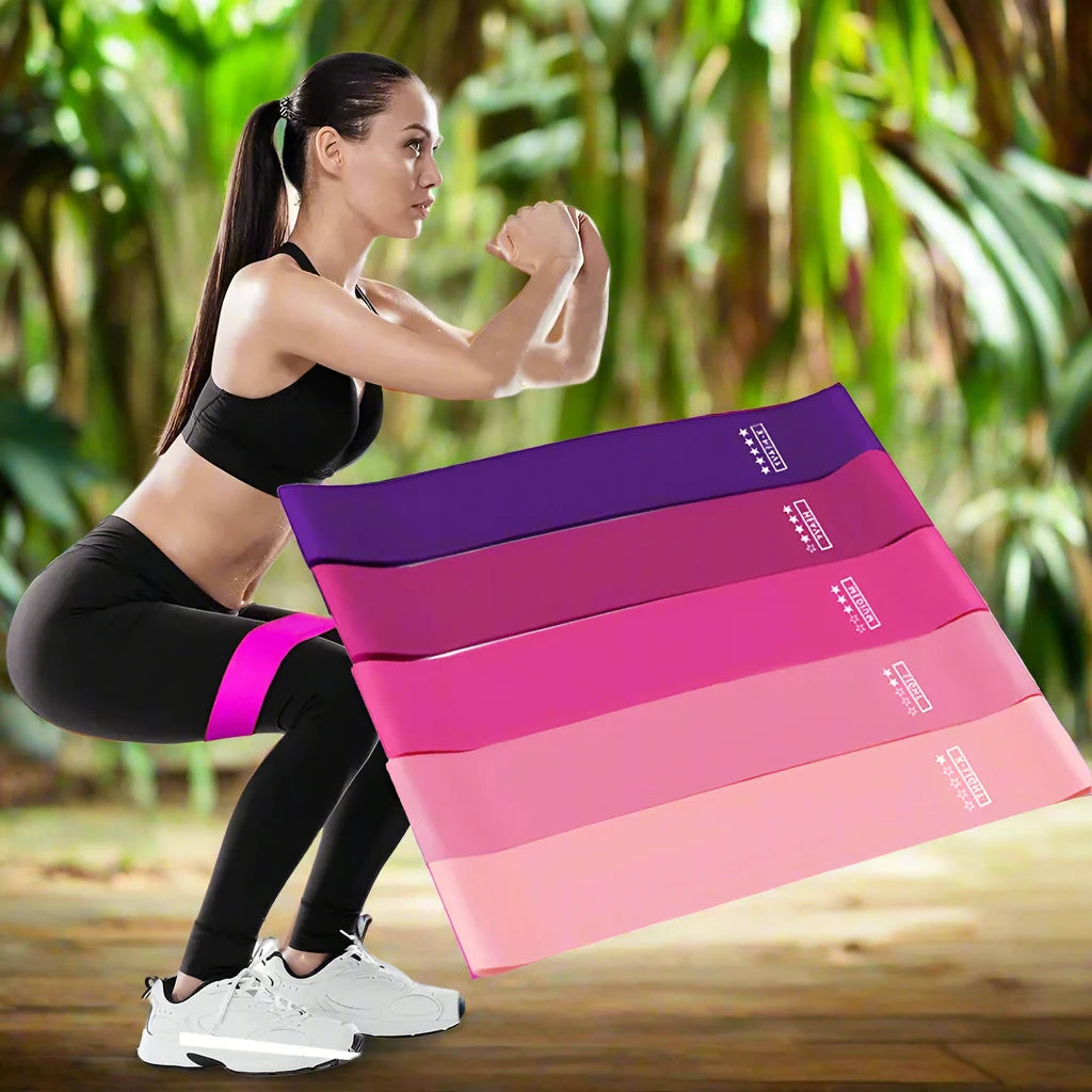 a woman kneeling down with a stack of yoga mats