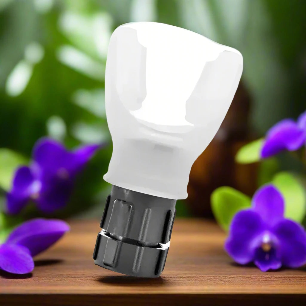 a white light bulb sitting on top of a wooden table