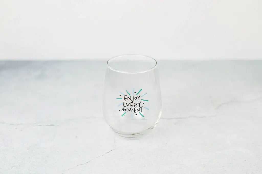 a wine glass that says enjoy every moment