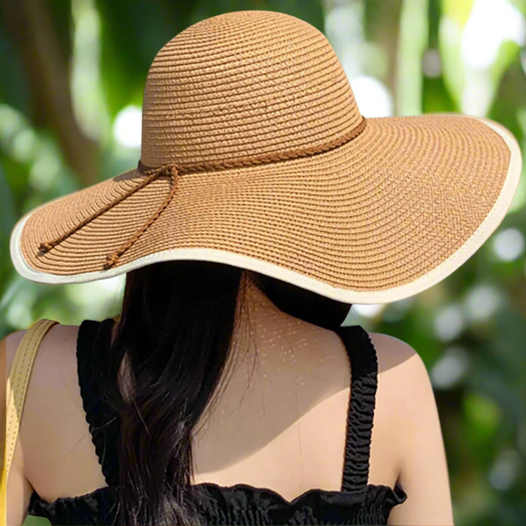 Back view of a woman showcasing the DRESHOW Womens Bowknor Straw Hat with a stylish wide brim. This foldable summer hat, perfect for spring, provides UPF 50+ sun protection. From Blooming Violets, it's a must-have for ladies seeking fashionable sun protection. The lightweight straw design makes it easy to roll up, ensuring convenience for any outdoor adventure. Get your womens sun hat with free shipping!