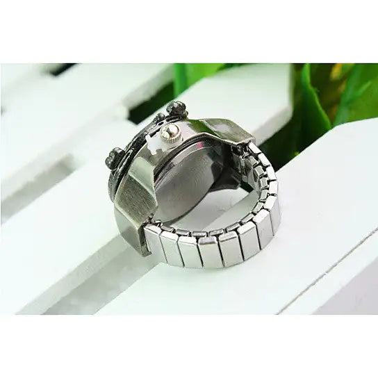 a watch sitting on top of a white bench