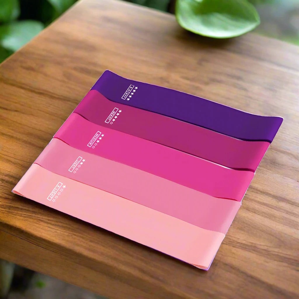 a wooden table topped with four different colored papers