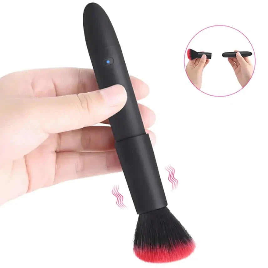 a hand holding a black and red makeup brush
