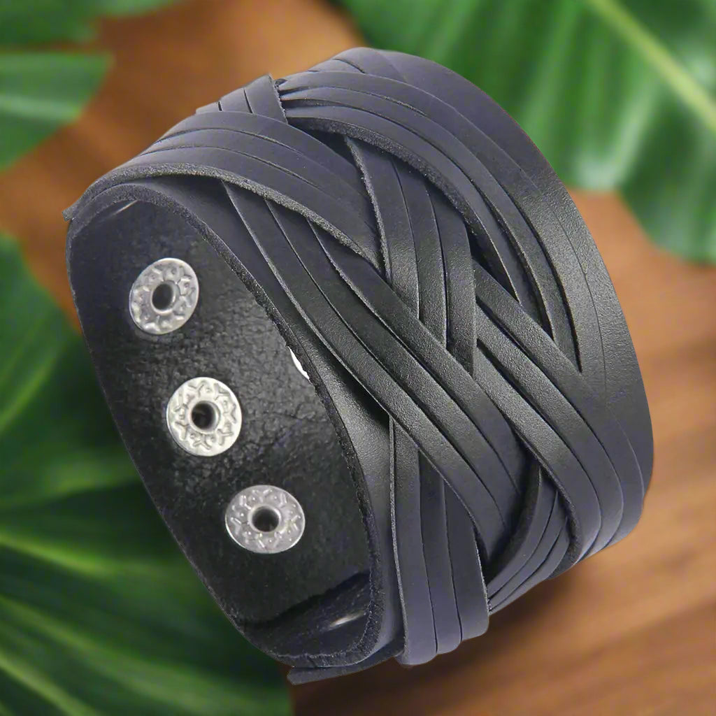 Top view of the GelConnie Leather Cuff Bracelet, highlighting its punk-inspired braided leather design. This stylish leather cuff bracelet from Blooming Violets is perfect for both men and women, making a bold fashion statement.
