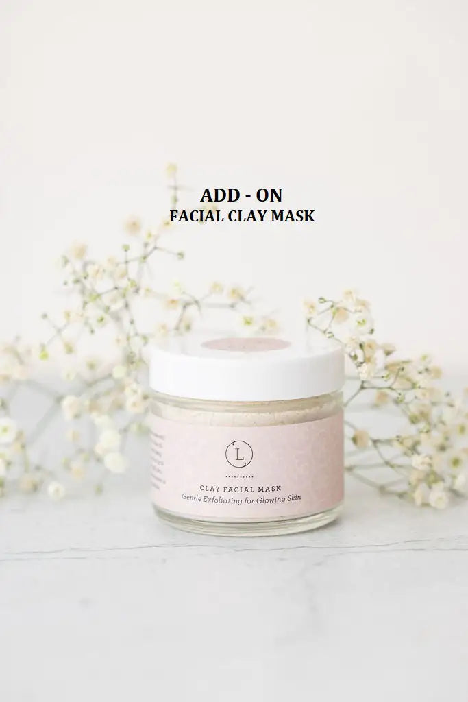 a jar of facial clay mask next to flowers