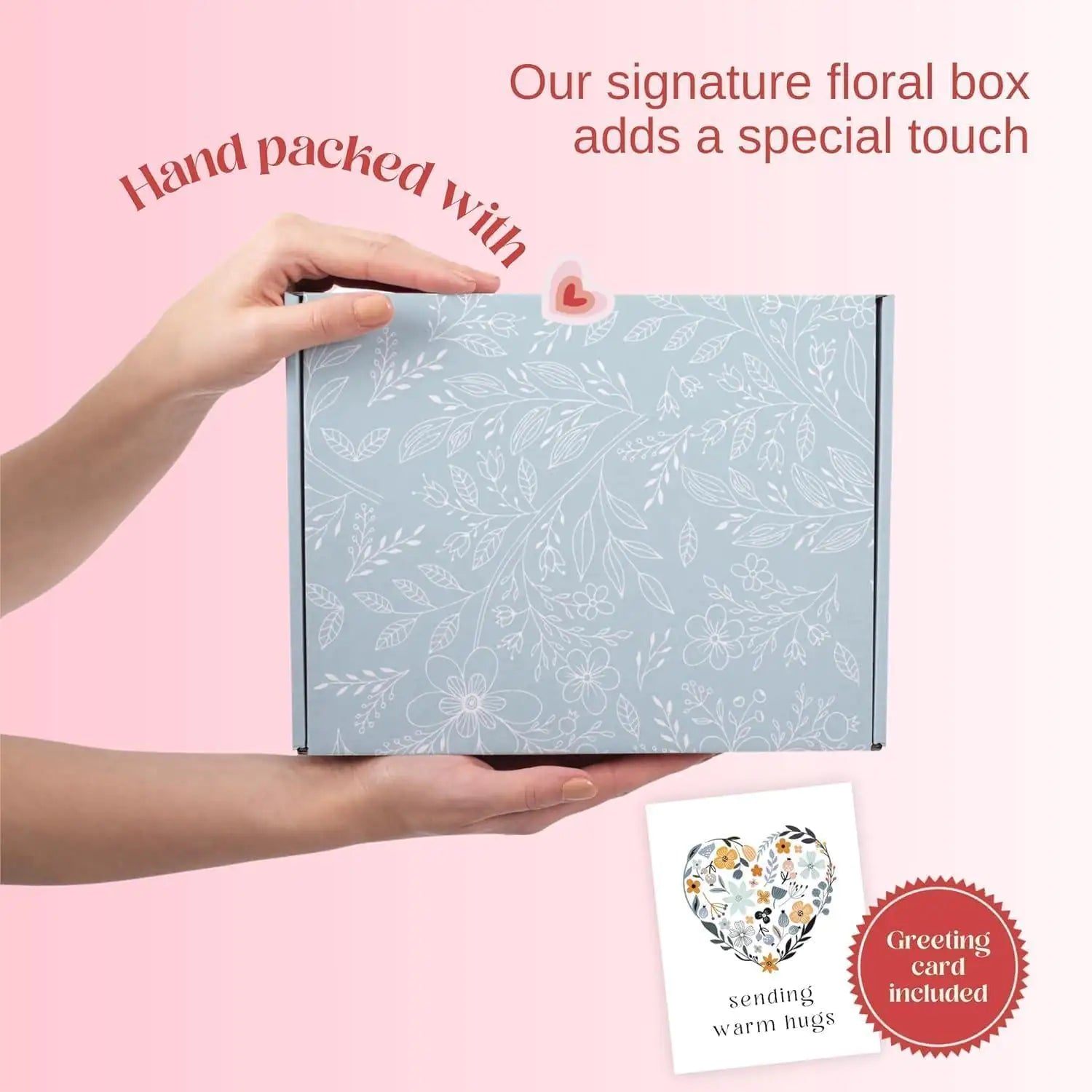 a person holding a box with a heart on it