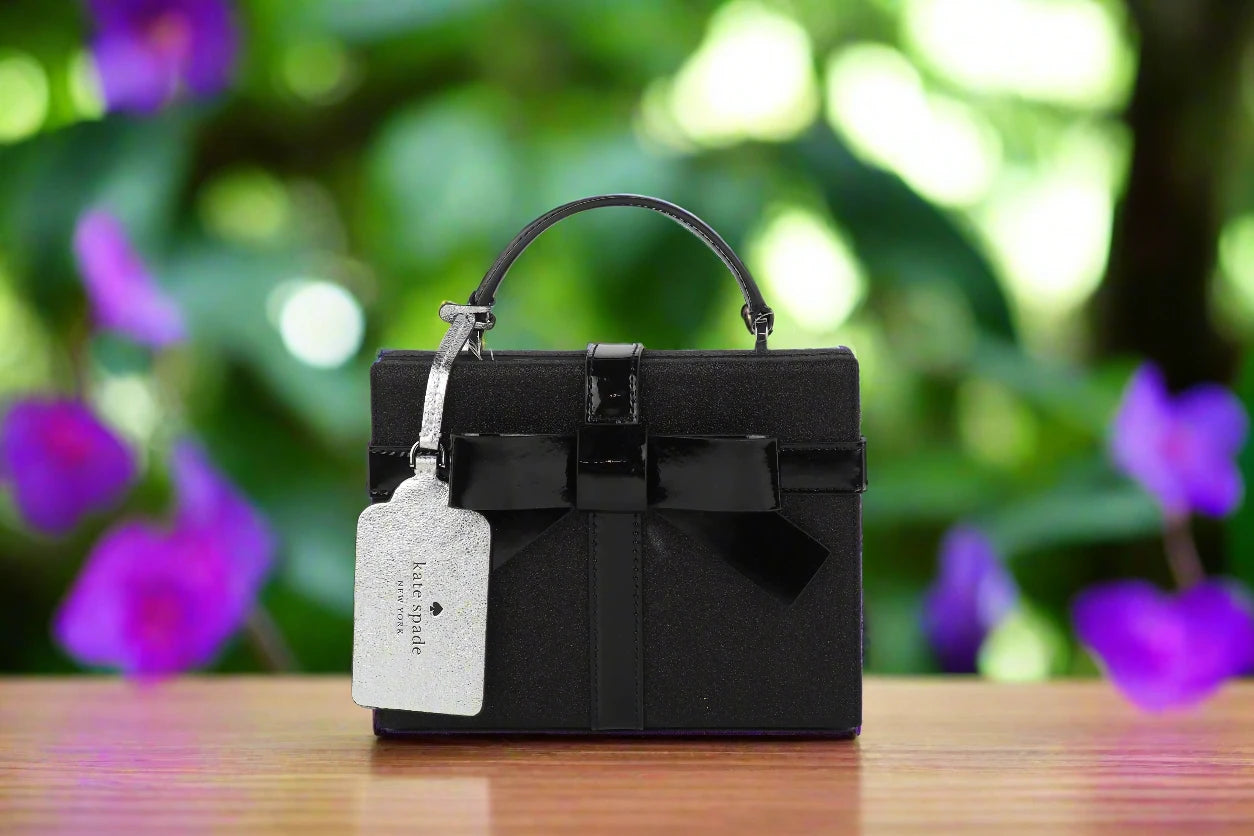 a black purse with a tag on it sitting on a table
