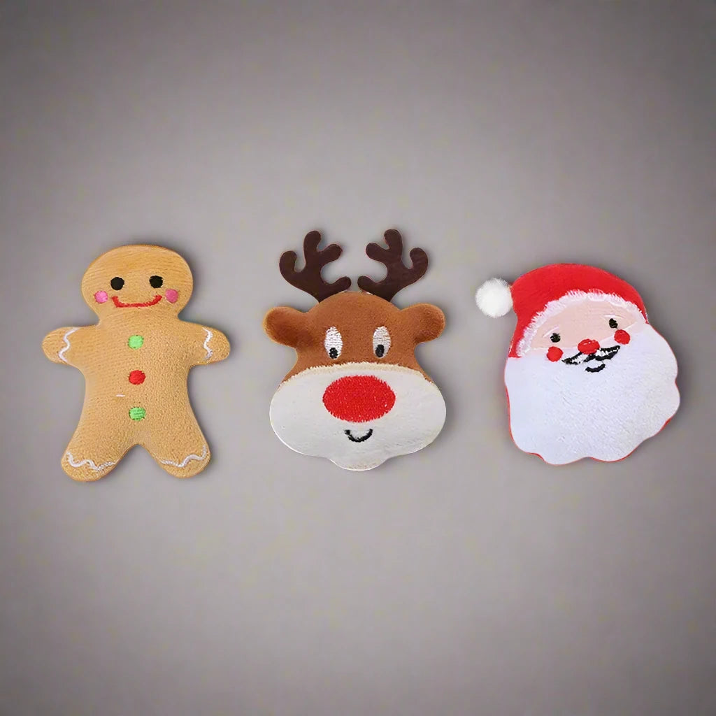 a group of three decorated christmas cookies sitting on top of a table