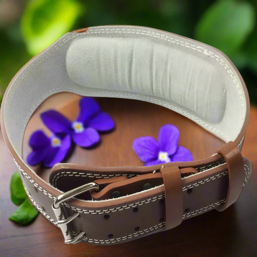 a leather belt with flowers on a wooden table
