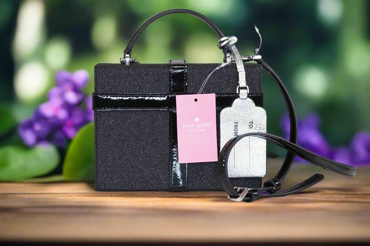 a black purse with a pink tag attached to it