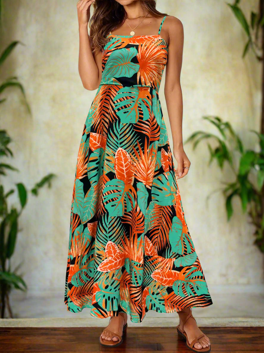 A woman wearing the MEROKEETY 2024 Summer Floral Boho Maxi Dress, showcasing a vibrant floral boho maxi dress design with green and orange tropical leaves. Perfect for spring and summer, this full-length dress features spaghetti straps, making it ideal for casual outings. From the Blooming Violets collection, this fashion-forward piece is perfect for ladies seeking comfortable and stylish options, and it includes free shipping.
