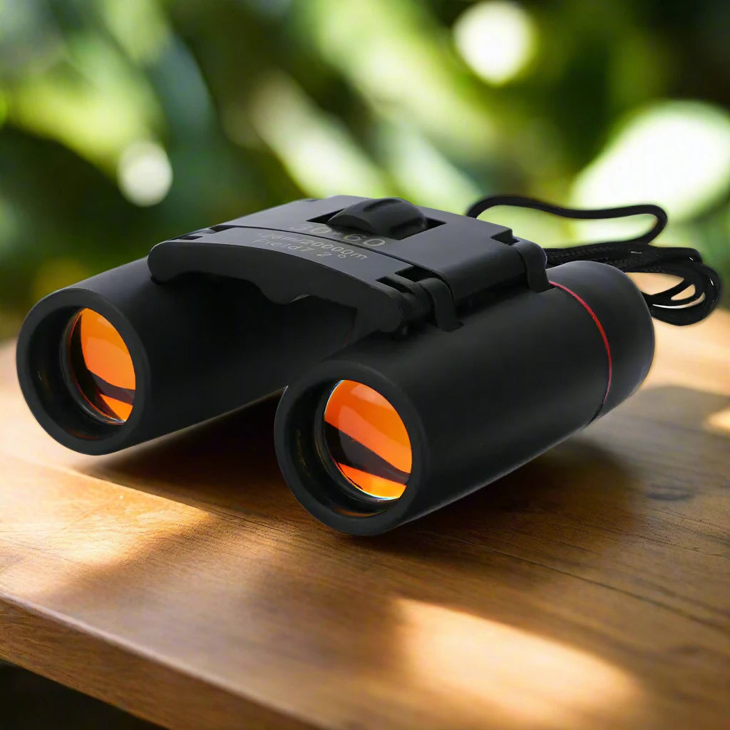 a pair of binoculars sitting on top of a wooden table