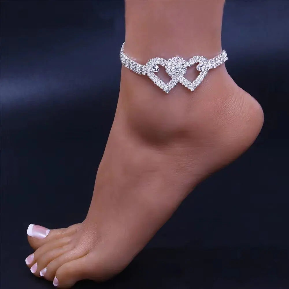a woman's foot with a diamond bracelet on it